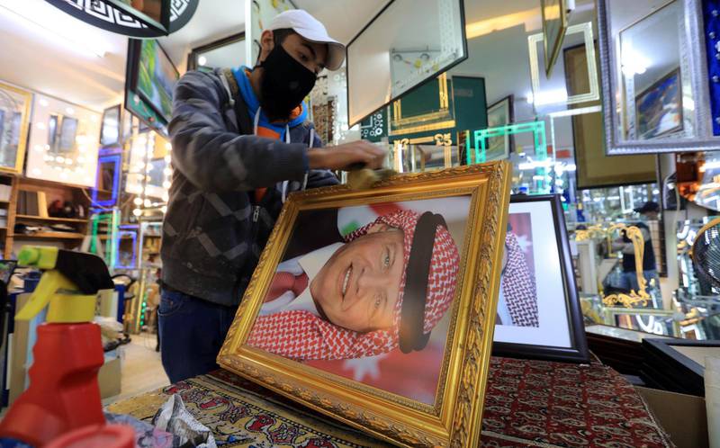 A frame maker in Amman displays a picture of king Abdullah II. EPA