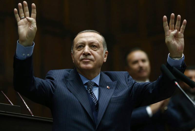 Turkey's President Recep Tayyip Erdogan addresses his supporters at the parliament in Ankara, Turkey, Tuesday, Nov. 28. 2017. Erdogan says a telephone conversation he held with U.S. President Donald Trump last week was the first time in a long while since Turkish and U.S. leaders were on the same "wavelength." (Pool Photo via AP)