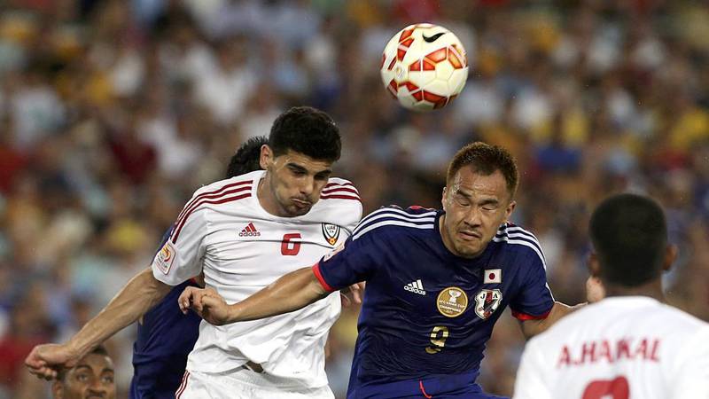 Mohanad Salem, left, fights for the ball against Japan's Shinji Okazaki. Reuters