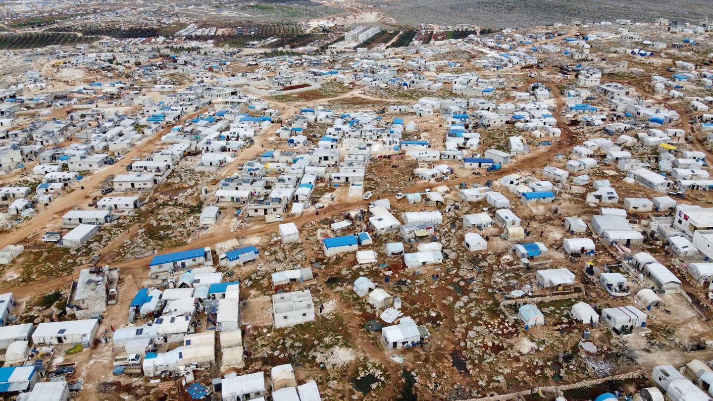 TOPSHOT - An aerial view taken on March 5, 2020 shows a camp for displaced Syrians in Deir Hassan village, in Idlib's northern countryside near the Turkish border, where the number of people seeking shelter has increased since the offensive by regime forces against the rebel-held bastions in the northwestern province. The offensive by Damascus, which Russia has supported with air power, has shrunk Syria's last rebel bastion and displaced close to a million people. / AFP / Aaref WATAD
