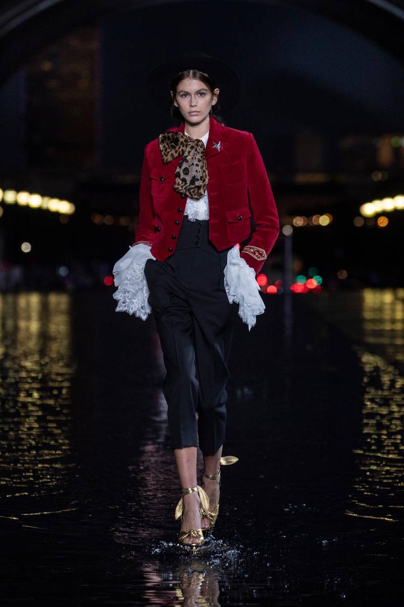 <p>Small flashes of colour appeared at Saint Laurent, such as this velvet jacket, worn with a leopardprint scarf</p>
