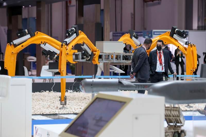 Khalifa University's stand featured a six-legged yellow robot that can carry a hefty 1,000 kilograms through challenging terrain. Khushnum Bhandari / The National