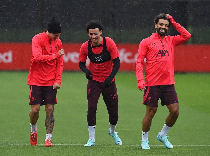 Kostas Tsimikas, Curtis Jones and Mohamed Salah enjoy the training session. 