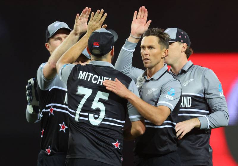 New Zealand bowler Trent Boult celebrates with teammates after the dismissal of Pakistan's Babar Azam. AFP