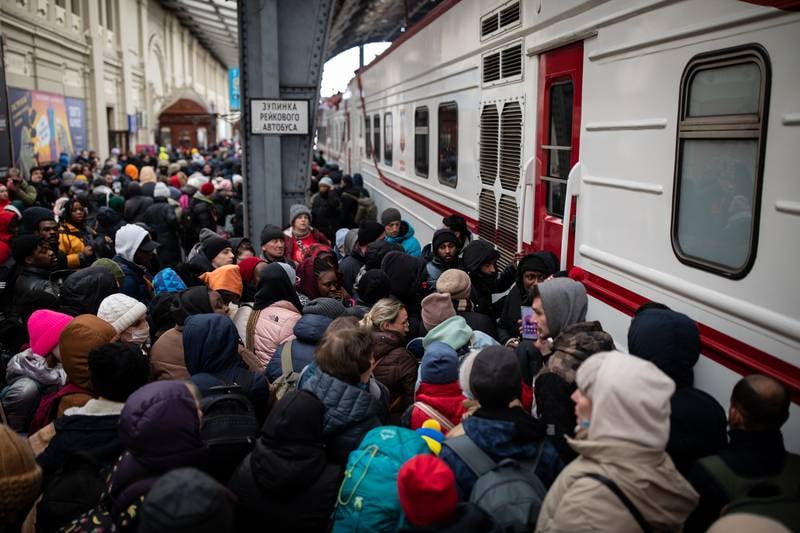 People desperate to leave Ukraine try to board a train at the railway station in Lviv on February 27. Oliver Marsden for The National