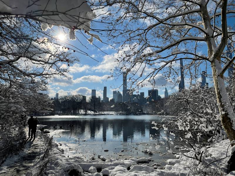 People walk in fresh snow in Central Park, New York. Reuters