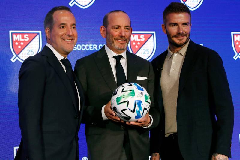 Inter Miami co-owners Jorge Mas, left, and David Beckham, right, pose for photos with Major League Soccer Commissioner Don Garber. AP