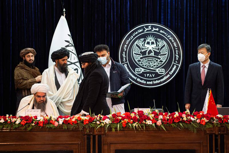 Afghanistan's acting minister of mines and petroleum Shahabuddin Dilawar, sitting left, its acting first deputy prime minister Abdul Ghani Baradar, second left, and China's ambassador to Afghanistan Wang Yu at the signing in Kabul. AFP