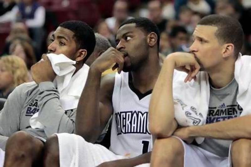 Sacramento Kings players, from left, Jason Thompson, Tyreke Evans and Francisco Garcia watch during the closing moments of their NBA basketball game against the Miami Heat in Sacramento, Calif., Saturday, Jan. 12, 2013. The Heat won 128-99. (AP Photo/Rich Pedroncelli) *** Local Caption *** HeatKings Basketball.JPEG-05fa7.jpg