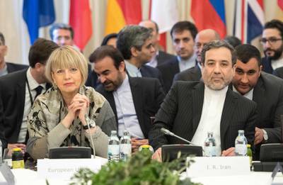 Abbas Araghchi (R), political deputy at the Ministry of Foreign Affairs of Iran, and the Secretary General of the European Union External Action Service (EEAS) Helga Schmid attend E3/EU+3 and Iran talks at Palais Coburg in Vienna, Austria on March 16, 2018.
Iran and the six parties to the 2015 nuclear deal are holding the regular review of implementation, as US President Donald Trump's firing of Rex Tillerson stokes fears about the accord's future. / AFP PHOTO / JOE KLAMAR