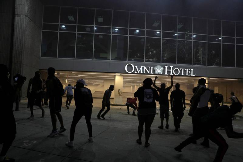 Protesters throw rocks at a hotel in Atlanta on May 29, 2020. Reuters