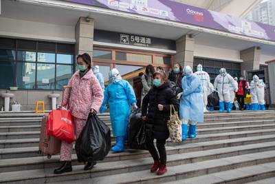 People who have recovered from the coronavirus leave a temporary hospital in Wuhan in China's central Hubei province.  AFP