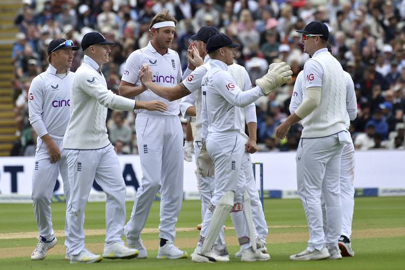 England bowler Stuart Broad, third left, celebrates with teammates following the dismissal of India's Cheteshwar Pujara for 66. AP