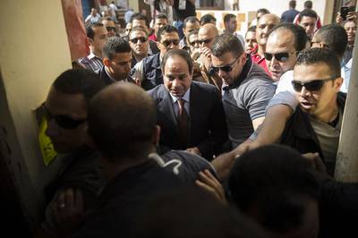 Mr El Sisi, centre, who quit the army in March to run for president, is riding a wave of popularity after ousting Islamist president Mohamed Morsi in July last year, and crushing his Muslim Brotherhood movement. Khaled Desouki/AFP Photo