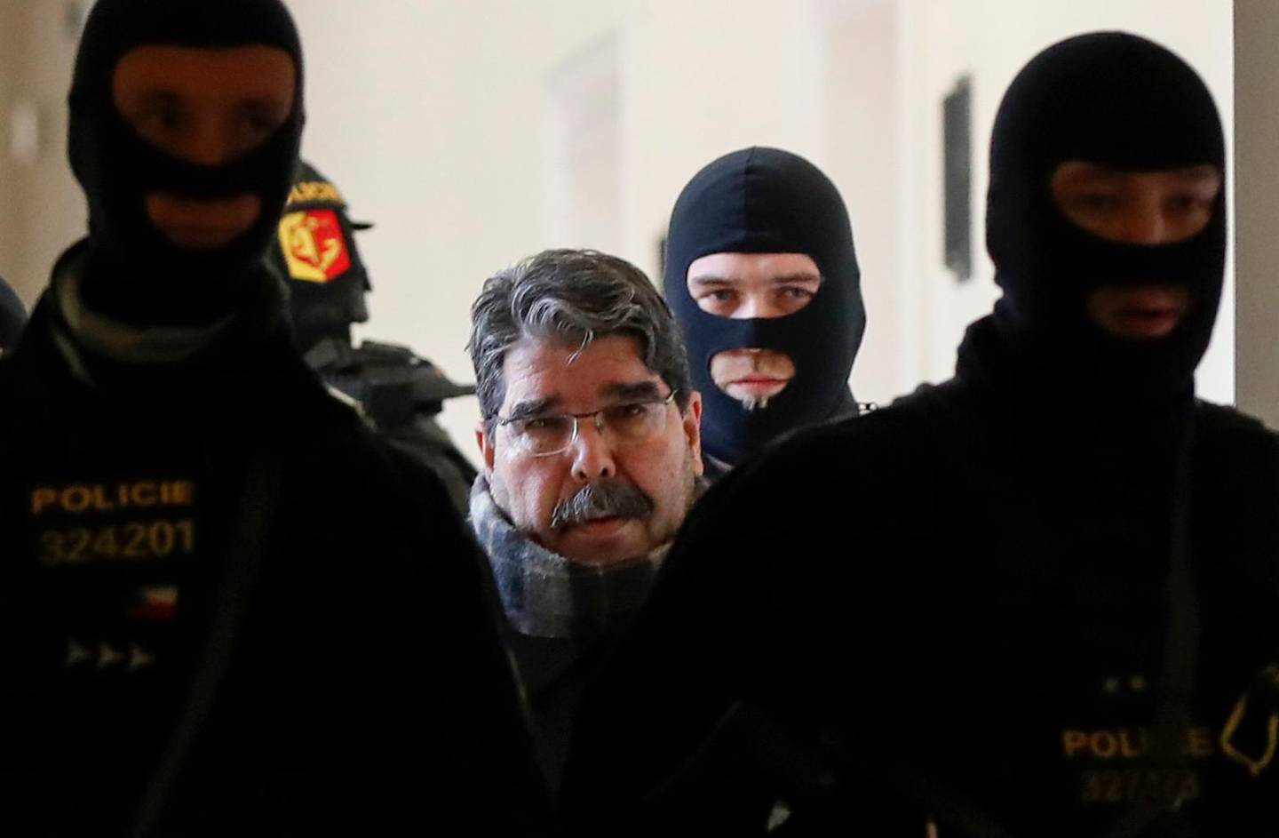 Syrian Kurdish leader Saleh Muslim (C) is escorted by Czech police for his trial at the municipal court on February 27, 2018 in Prague.
A Czech court released Muslim, who was detained at the weekend and is wanted by Turkey on terror charges, his lawyer said. The former leader of the Syrian Kurdish Democratic Union Party (PYD) is still a figurehead for Kurds in Syria. / AFP PHOTO / Stringer / ALTERNATIVE CROP 