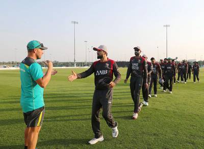 Abu Dhabi, United Arab Emirates - October 22, 2018: Captain of the UAE Rohan Mustafa and captain of Australia Aaron Finch shake hands at the end of the match between the UAE and Australia in a T20 international. Monday, October 22nd, 2018 at Zayed cricket stadium oval, Abu Dhabi. Chris Whiteoak / The National