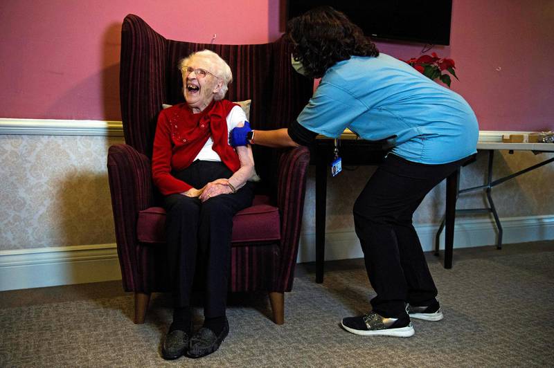 Ellen Prosser, known as Nell, who is 100 years old, receives the Oxford/AstraZeneca COVID-19 vaccine from Dr Nikki Kanani at the Sunrise Care Home, amid the coronavirus disease pandemic in Sidcup, Britain. Reuters