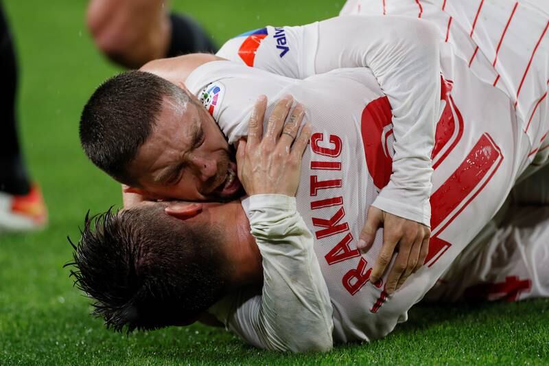 Sevilla midfielder 'Papu' Gomez celebrates with teammate Ivan Rakitic after scoring the opening goal. EPA