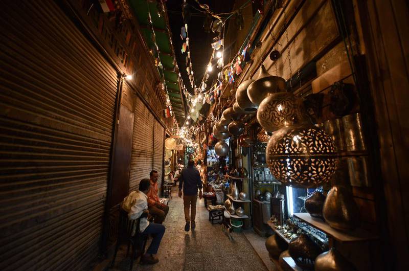 People walk at the Khan El Khalili market in Cairo, Egypt. A new law means all products must have an indelible price stamped on them. Mohamed El-Shahed / AFP