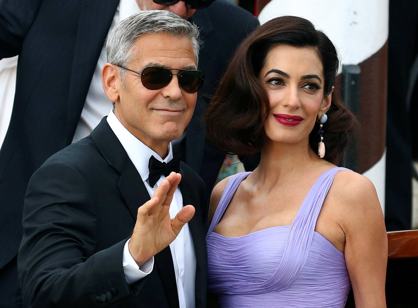 Actor and director George Clooney waves next to his wife Amal as they leave the hotel before the red carpet for the movie Suburbicon at the 74th Venice Film Festival in Venice, Italy September 2, 2017. REUTERS/Alessandro Bianchi