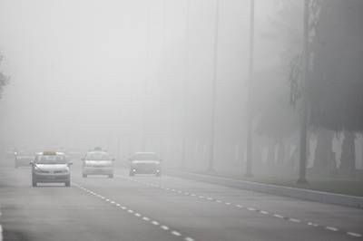 United Arab Emirates - Abu Dhabi - January 27th, 2009:  Cars drive through the morning fog on 24th street..  (Galen Clarke/The National)   *** Local Caption ***  GC03_01272009_fog.jpg