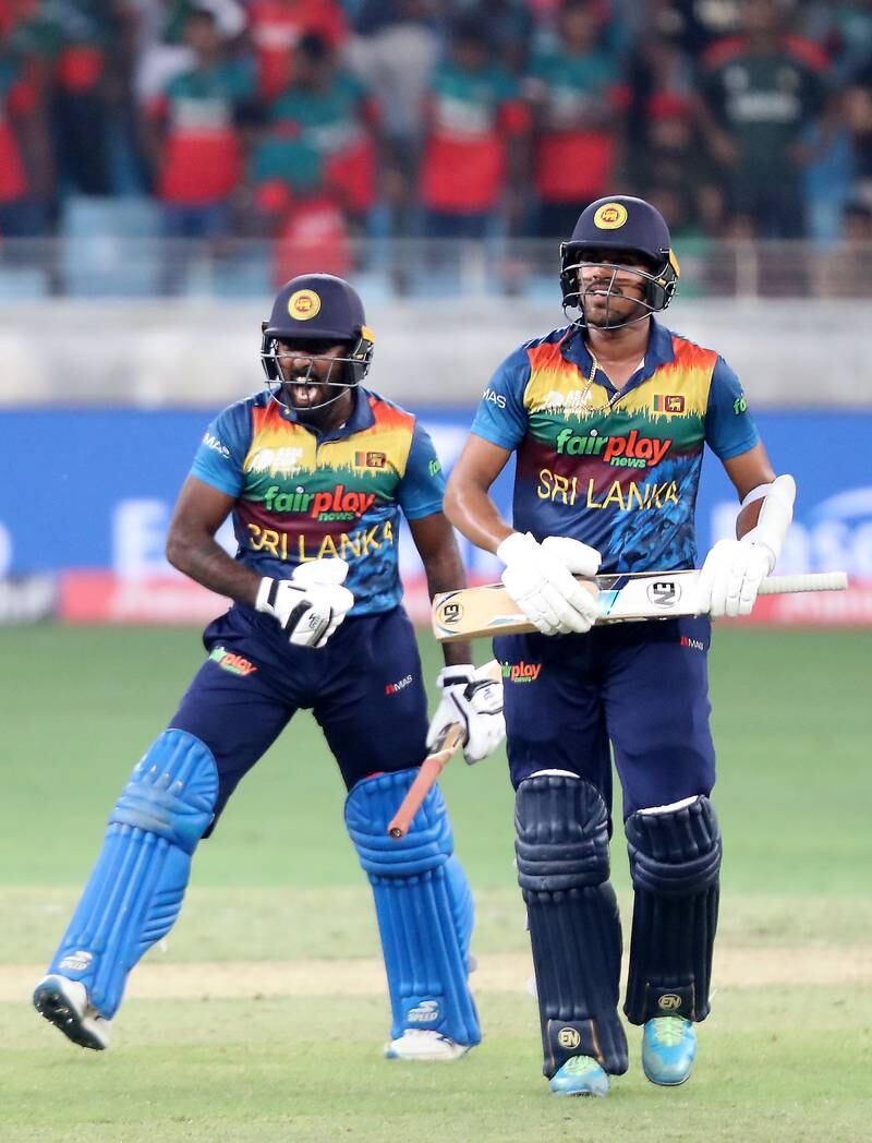 Sri Lanka's Maheesh Theekshana and Asitha Fernando celebrate after beating Bangladesh by two wickets. Pawan Singh / The National