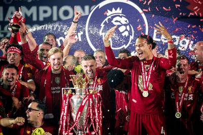 Liverpool captain Jordan Henderson and his teammate Virgil van Dijk with the Premier League trophy. EPA
