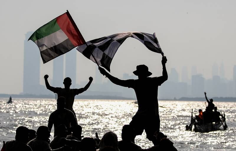 Flags are waved and fists pumped as members of Al Asifa boat team celebrate their win.