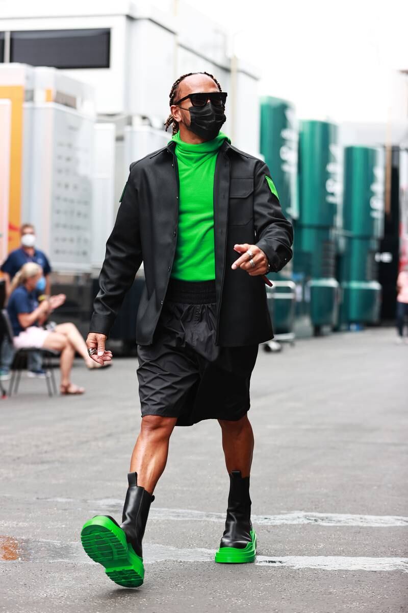 Lewis Hamilton, in black shorts and a jacket with pops of lime green, ahead of the F1 Grand Prix of France on June 17, 2021. Getty Images
