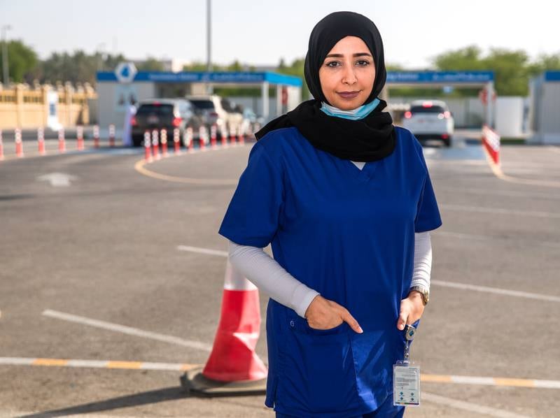 Name: Yusra Al Antari
Age: 38
Nationality: Emirati.
Work: PCR technician at Seha Covid-19 drive-through centre, Al Manhal, Abu Dhabi, for 13 months.
Past work: Charge nurse at School Health.
Question: What has been the biggest challenge you've faced while being a PCR frontline worker? Answer: "Nurses will remain key players in stopping the pandemic with adequate assistance, as they have a direct exposure with the patients which put them at high risk of infection, therefore as a charge nurse I have to make sure that we have appropriate infection control procedures and sufficient personal protective equipment all the time. Thus, they must be provided with a healthy work environment (such as free to comment to reports of abuse or infection control risks) to empower their efforts to control and manage the outbreak." All photos by Victor Besa / The National