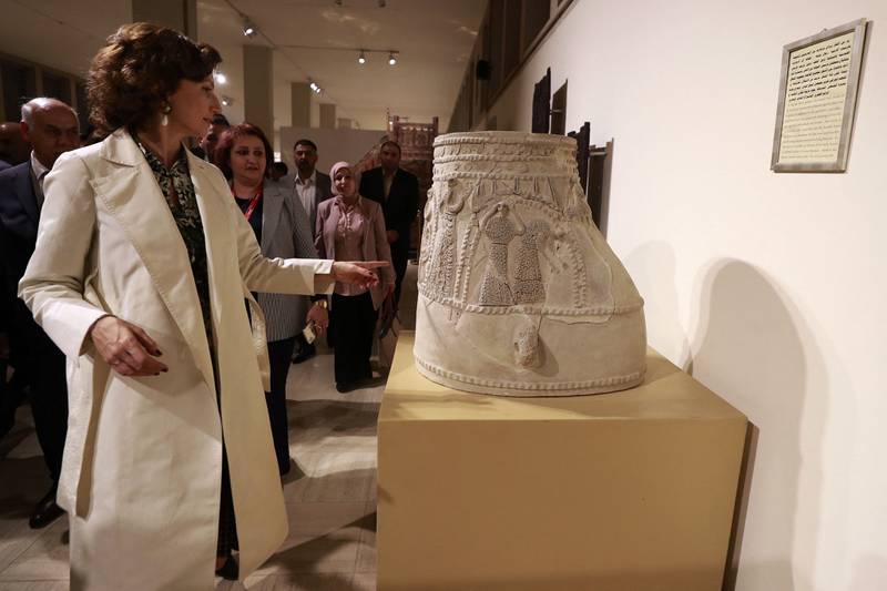 Ms Azoulay checks a historical piece at the national museum in Baghdad.  AFP