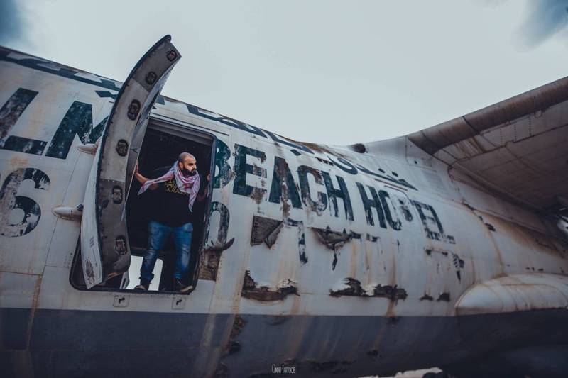 Emirati filmmaker Aiham Al Subaihi looking out of the abandoned plane in Umm Al Quwain. Photo: Omar Tartoub 
