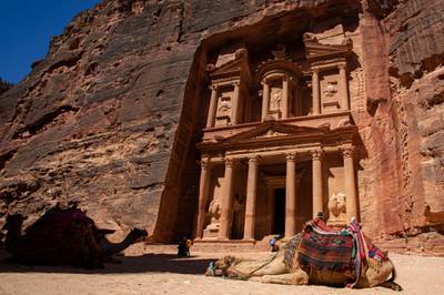 Camels rest in front of the Treasury building at the reopened Petra archeological site, in Petra. EPA