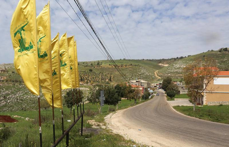 Hezbollah flags flutter along an empty street, amid the coronavirus disease (COVID-19) outbreak, at the entrance of Mays Al-Jabal village, Lebanon March 26, 2020. REUTERS/Aziz Taher