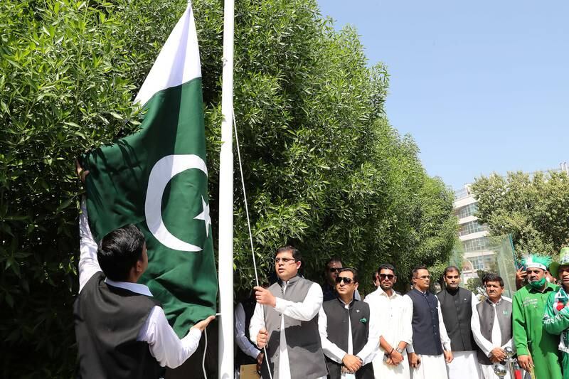 Mr Khan raises the Pakistani national flag at the consulate general in Dubai.