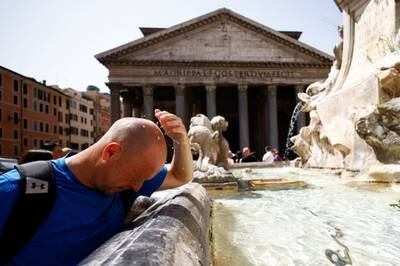 A man cools off at a fountain near the Pantheon in Rome, Italy. Reuters