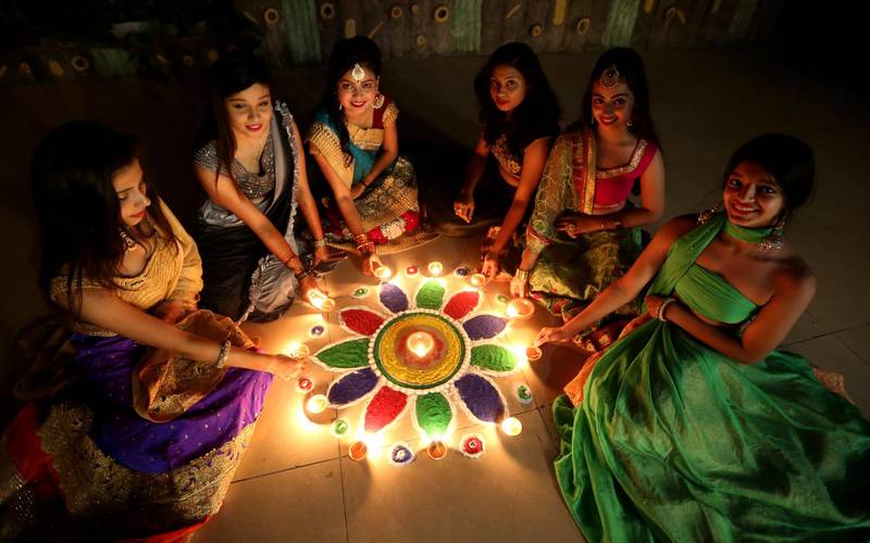 Young women light lamps on occasion of Diwali festival celebrations in Bhopal, India, on October 26, 2019. EPA