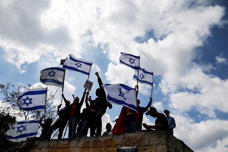 Protesters hold flags aloft in Jerusalem. Reuters