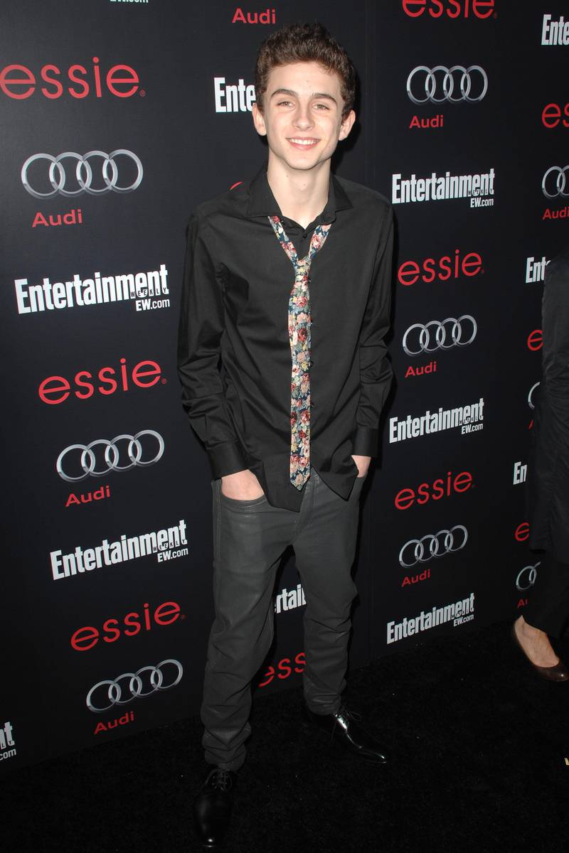 Timothee Chalamet, in a black shirt and floral tie, attends the 'Entertainment Weekly' Screen Actors Guild nominees' party in Hollywood, California, in January 2013. Sipa USA