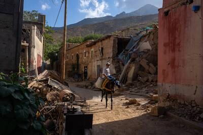 A boy rides a pony past the rubble of a collapsed building in Tnirte. Getty Images