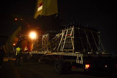 Part of the oxygen cylinder consignment being loaded into a Republic of Singapore Air Force C-130 aircraft to be sent to West Bengal, India to support the country's fight against the COVID-19 pandemic. EPA/Singapore's Ministry of Defence