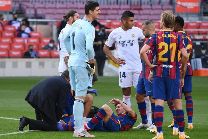 Barca's Lionel Messi receives treatment in the first half. AFP