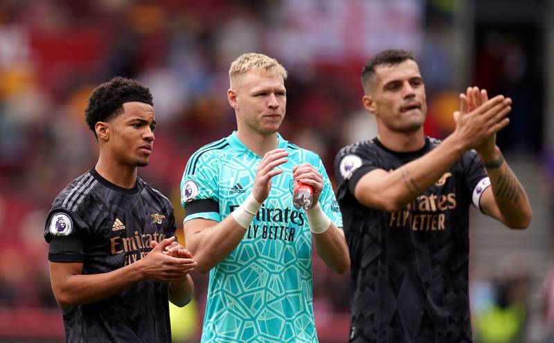 Arsenal's 15-year-old Ethan Nwaneri, goalkeeper Aaron Ramsdale and Granit Xhaka applaud the fans after the 3-0 Premier League win at Brentford.  PA