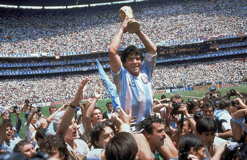 FILE - In this June 29, 1986 file photo, Diego Maradona holds up his team's trophy after Argentina's 3-2 victory over West Germany at the World Cup final soccer match at Azteca Stadium in Mexico City. The Argentine soccer great who was among the best players ever and who led his country to the 1986 World Cup title before later struggling with cocaine use and obesity, died from a heart attack on Wednesday, Nov. 25, 2020, at his home in Buenos Aires. He was 60. (AP Photo/Carlo Fumagalli, File)