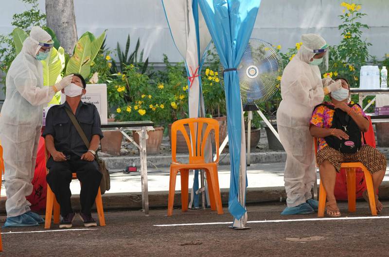 Health workers test residents for the coronavirus in Bangkok, Thailand. AP Photo