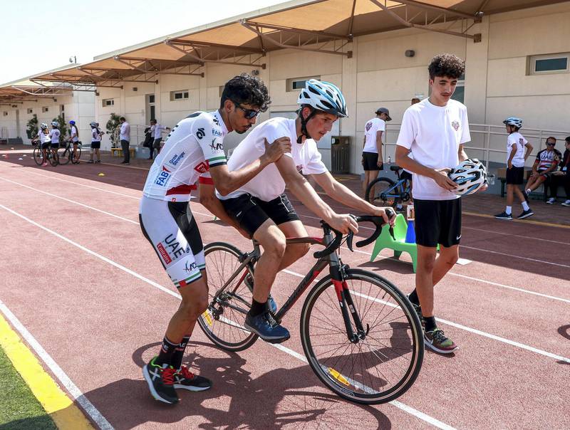 Abu Dhabi, U.A.E., October 29, 2018.  UAE Cycling Team Emirates visit the Al Yasmina School to give a brief cycling workshop.  Yousif mirza teaches Saif Al Ali how to ride a bike.Victor Besa / The NationalSection:  SPReporter:  Amith Passela