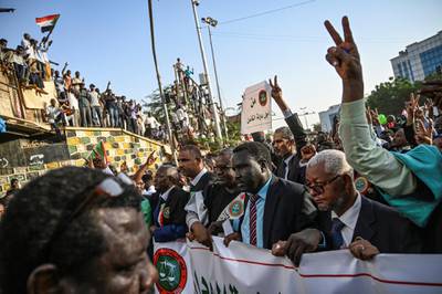 Sudanese judges, dressed in their robes, gather for a "million-strong" march outside the army headquarters in the capital Khartoum on April 25, 2019. - Sudanese protesters began gathering for a "million-strong" march to turn up the heat on the ruling military council after three of its members resigned following talks on handing over power. (Photo by OZAN KOSE / AFP)