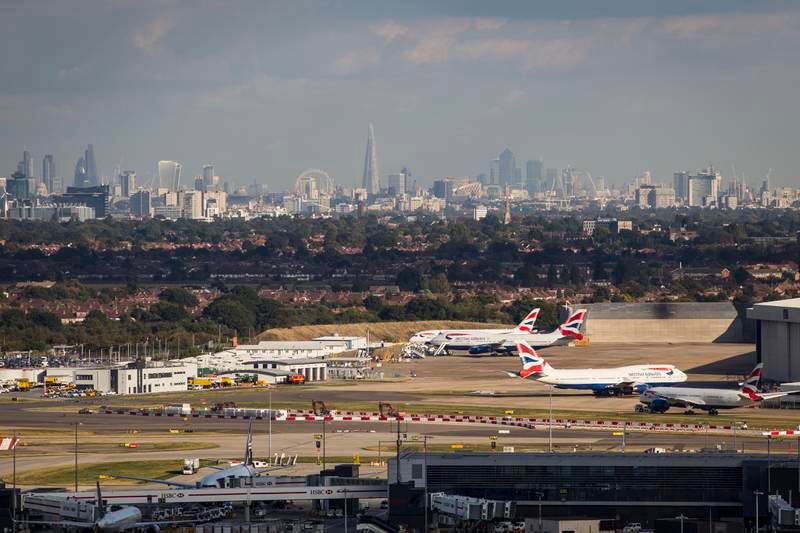 Aircraft at Heathrow Airport in front of the London skyline in 2016.