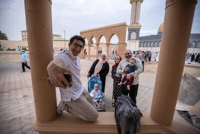 A family selfie after prayers on the first morning of Eid Al Adha in Abu Dhabi. Victor Besa / The National