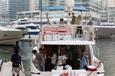 DUBAI , UNITED ARAB EMIRATES , JUNE 03 – 2018 :- Tourists after taking the yacht ride at Dubai Marina in Dubai.  ( Pawan Singh / The National )  For News.